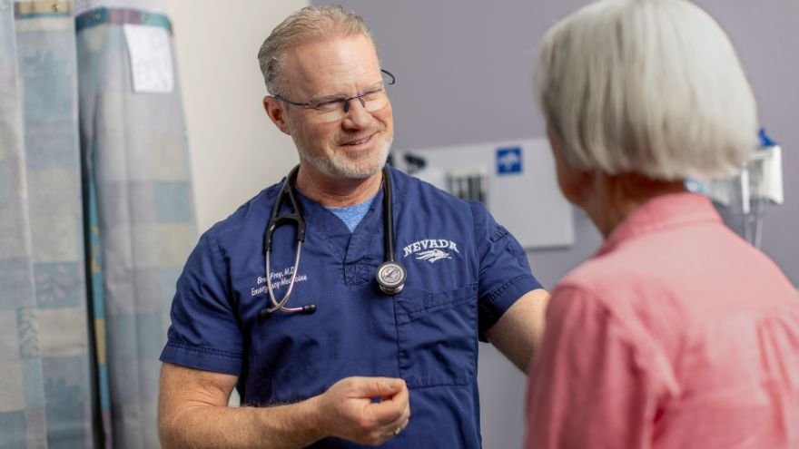 Emergency room physician comforts patient in ER