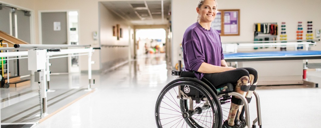 Patient in wheelchair receiving physical therapy treatment