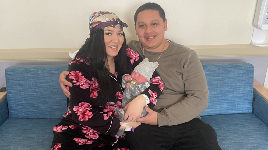 Baby Ermias and his parents pose for a photo on his birthday, New Year's Day 2025.