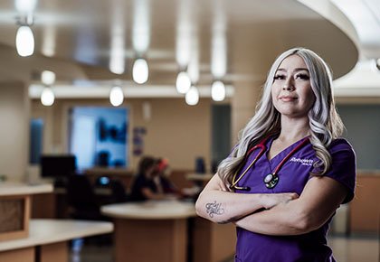 Renown nurse standing with arms crossed