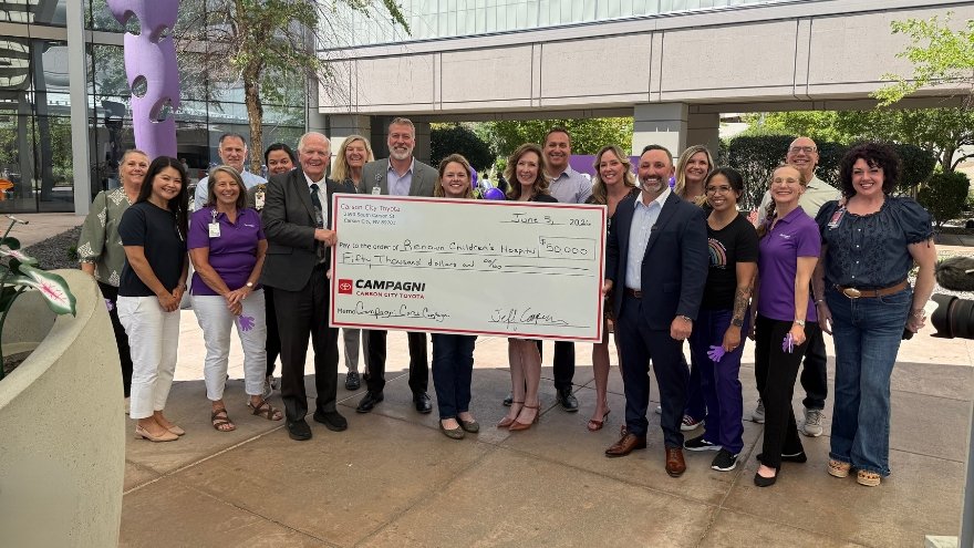 Team members from Renown Health and Campagni Auto Group pose with a giant $50,000 check supporting Renown Children's Hospital.