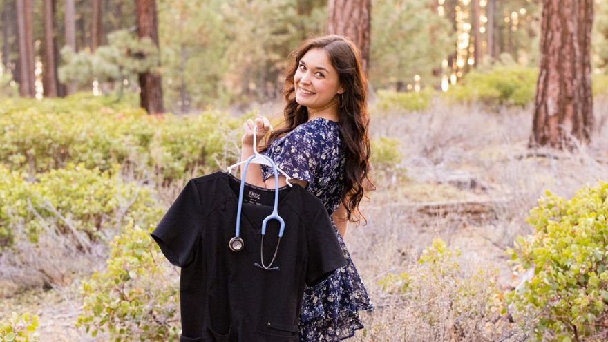 Callee posing for graduation photos with nursing attire