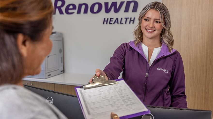 Renown Patient Access Representative checking in patient at Urgent Care 