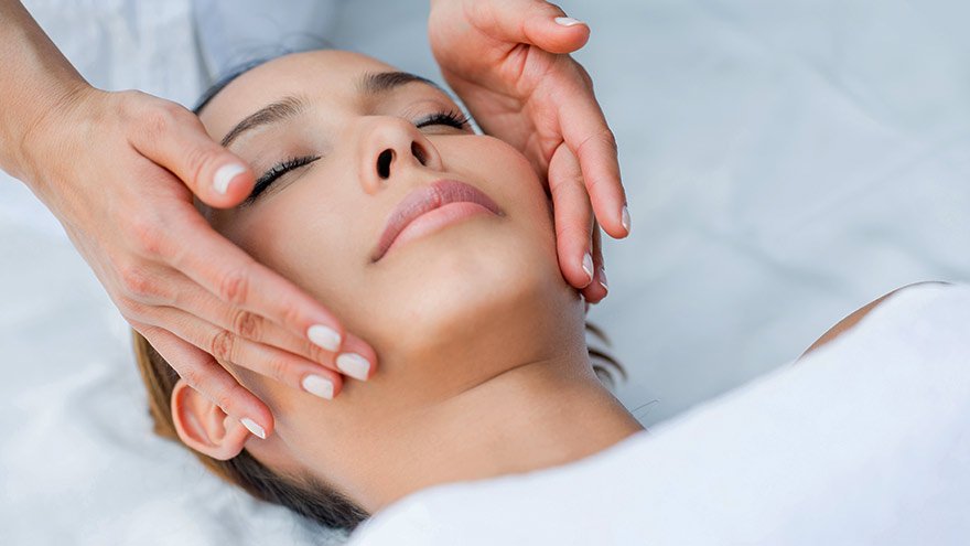 Beautiful Asian enjoying a relaxing facial treatment