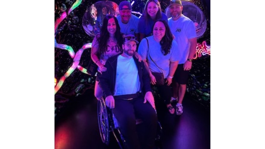 Jason Simpson poses with coworkers and family