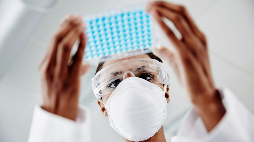 A researcher works on clinical research study findings in the lab.