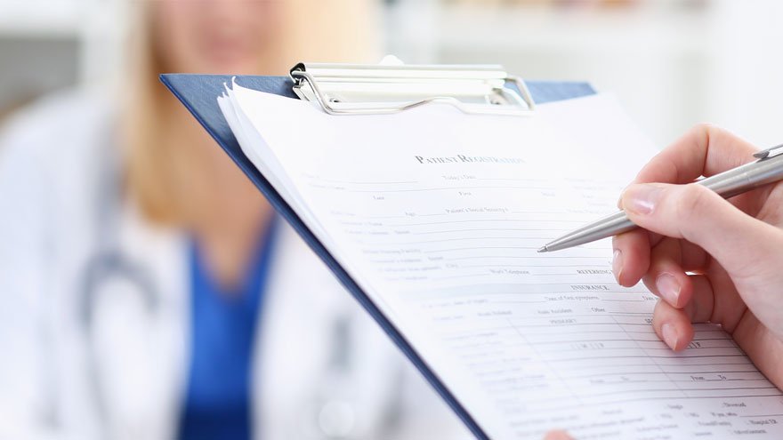 Provider filling out paperwork on a clipboard