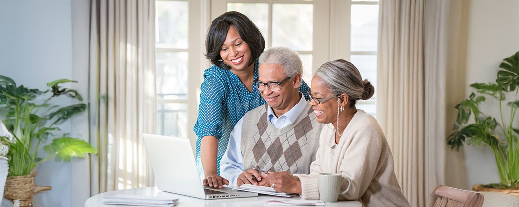 A women helping her parents utilize a laptop to access MyChart
