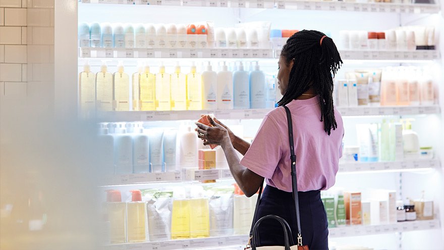 Woman deciding which sunscreen product to select