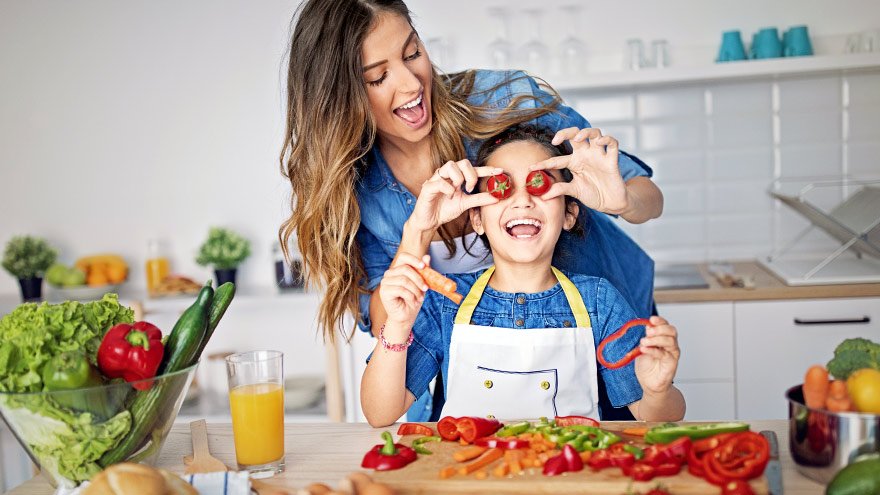 Mom and daughter having fun in kitchen