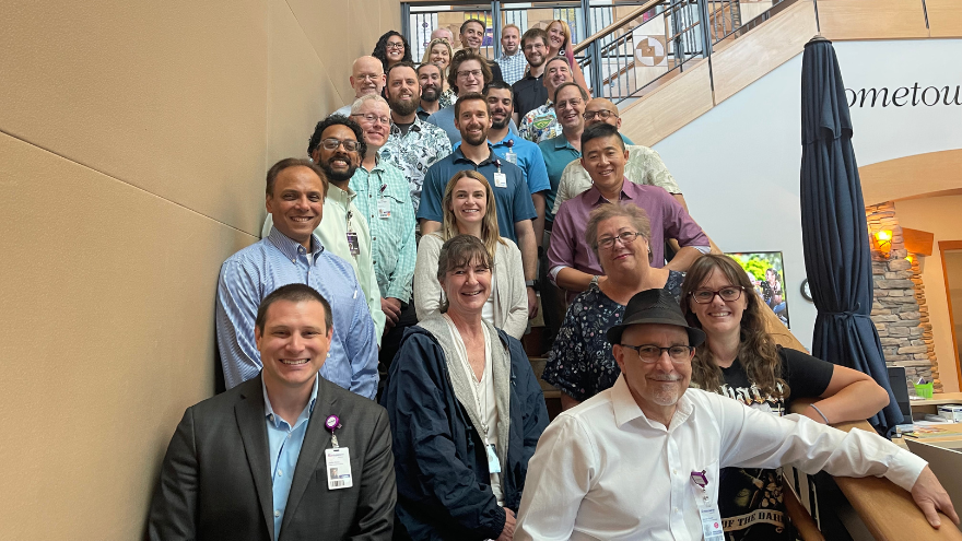 The Enterprise Data & Analytics team poses on a staircase for a group photo.