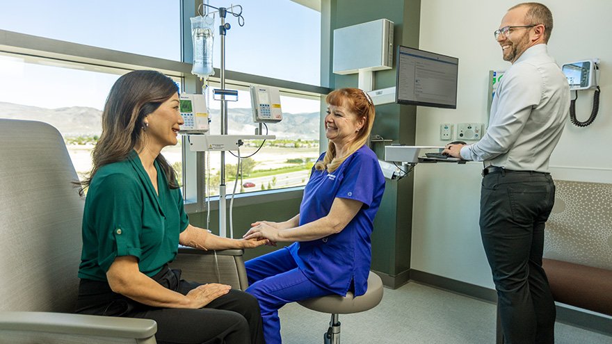 Doctors and patient having a friendly conversation in an infusion suite