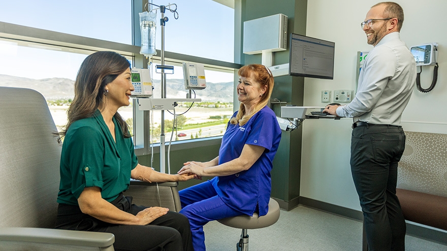 Doctors and patient having a friendly conversation in an infusion suite