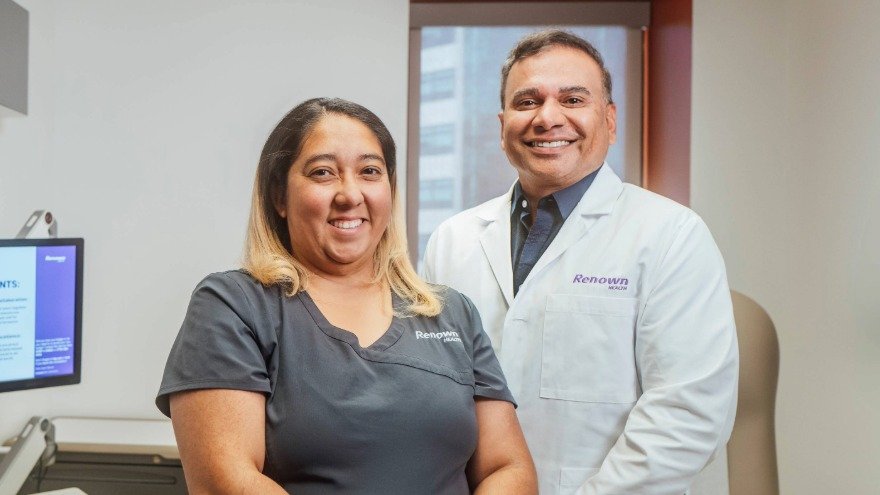 Medical Assistant Standing With Physician