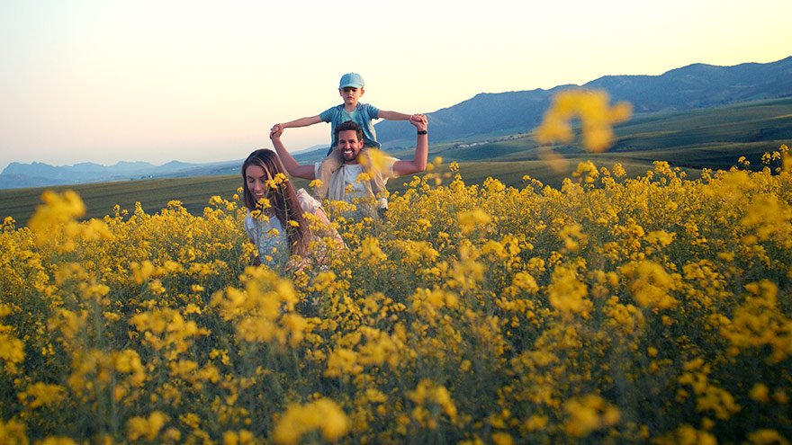 Family walking in field of wildflowers