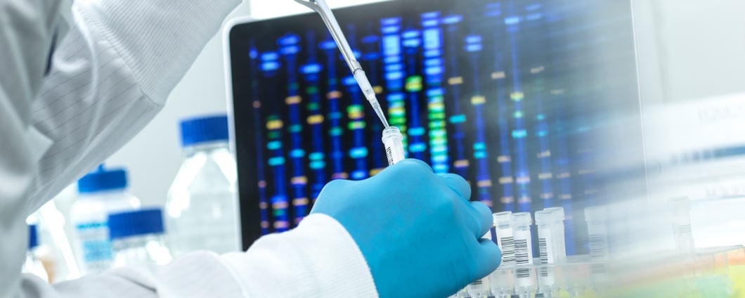 Scientist pipetting sample into a vial for DNA testing