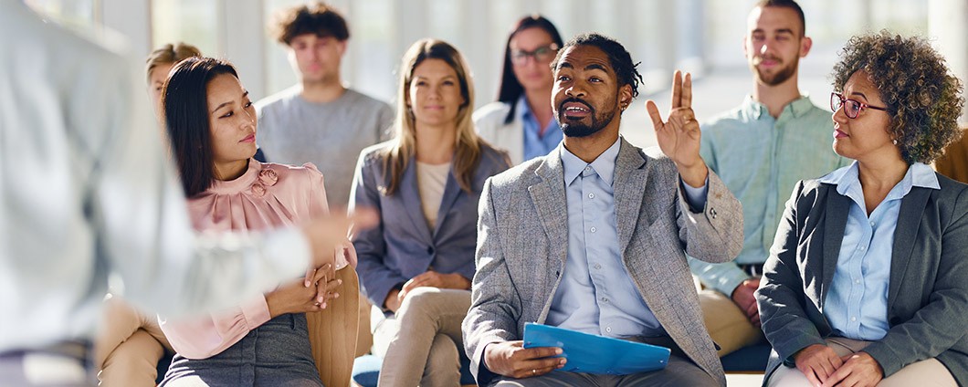 Clinical trial participant asking question in group setting