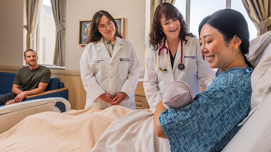 Renown and UNR Providers supporting new mom holding baby while father looks on