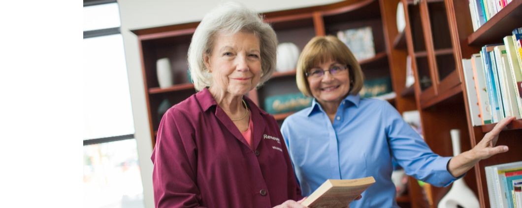 two women in library looking at books