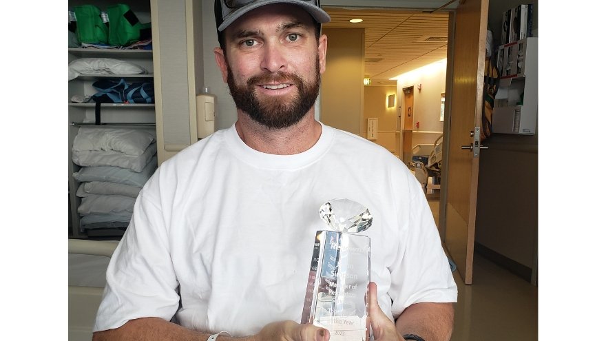 Jason Simpson holding his Top Talent award from Renown.