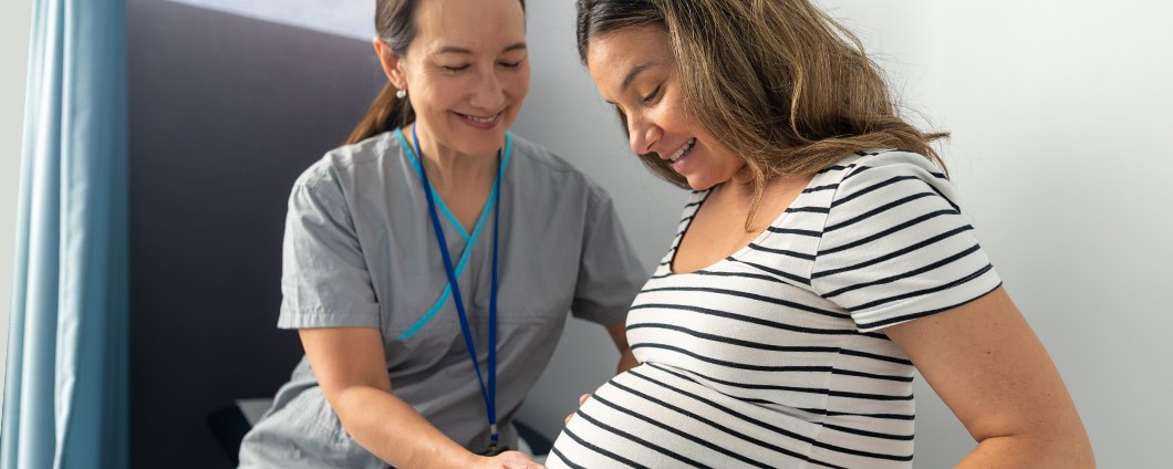 Midwife examining pregnant woman