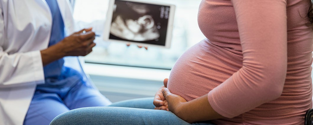 Provider explaining findings to pregnant woman