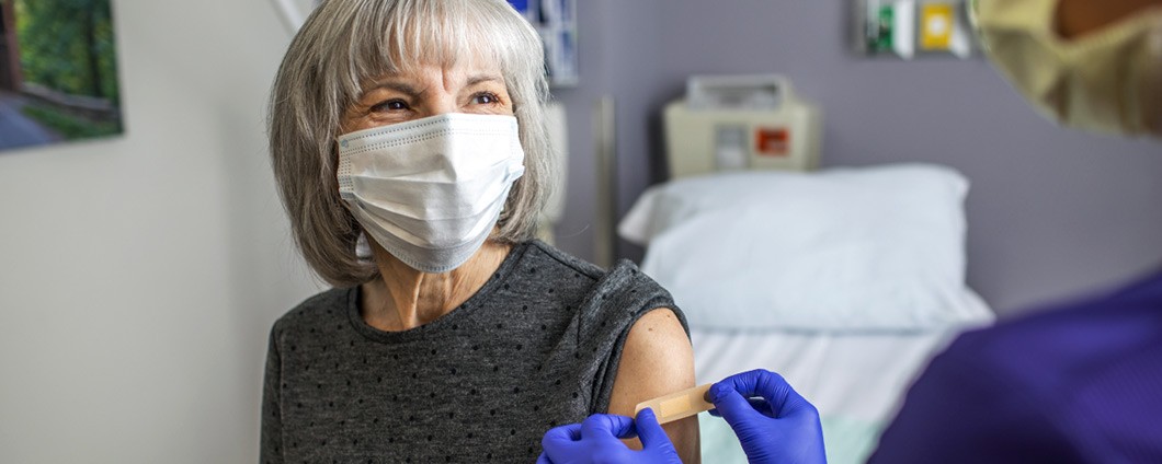 Woman speaking with provider after receiving vaccination