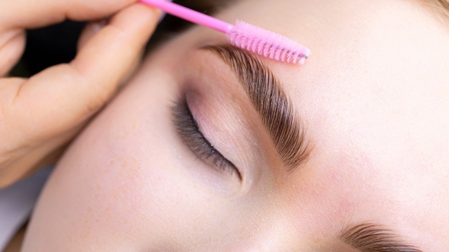 Woman getting a brow wax treatment