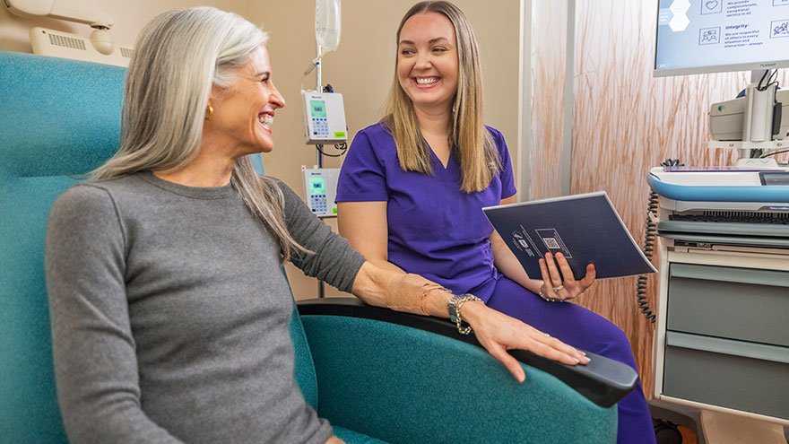 Renown nurse sits with oncology patient