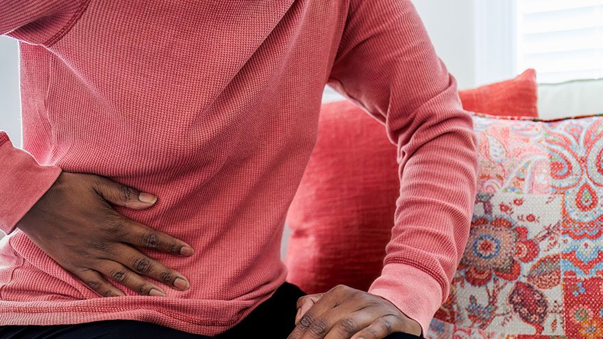 Women holding abdomen. 