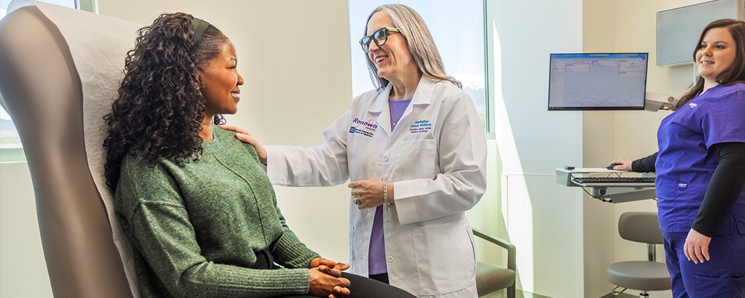Renown provider speaks with patient as Renown nurse looks on