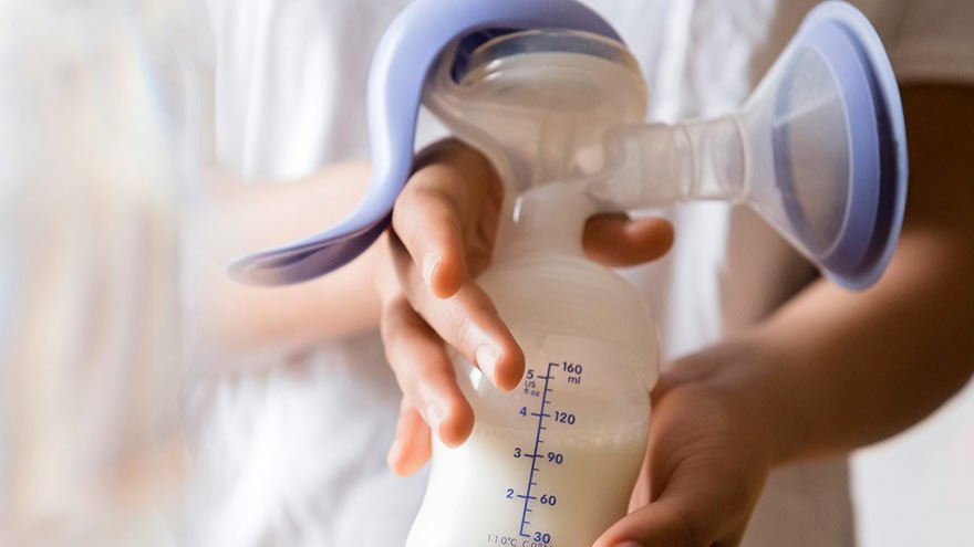 New mom holding breast milk container