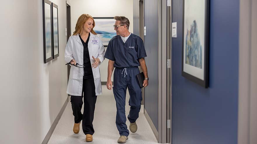 Urgent Care provider and MA consulting in hallway