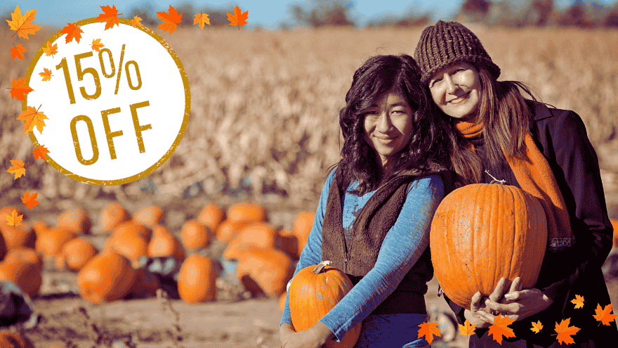 Friends posing for photo in a pumpkin patch