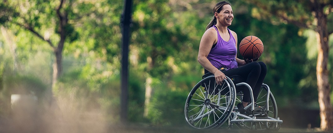 Young woman playing wheelchair basketball