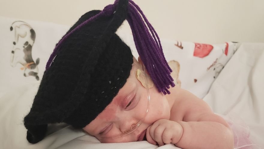 Sloan with a NIC graduation cap on
