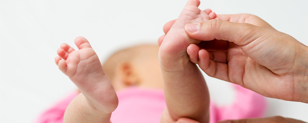 Doctor holding foot of baby