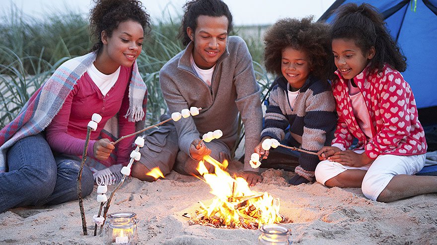 A family sitting around a bonfire
