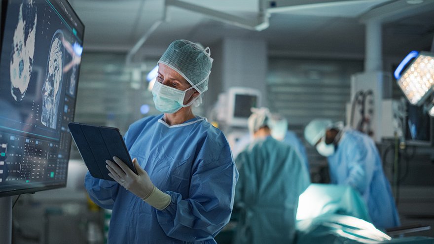 Lead Surgeon Reviews Critical Brain Scans Displayed on a Monitor