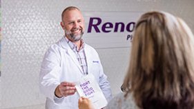 Pharmacist giving medication to patient