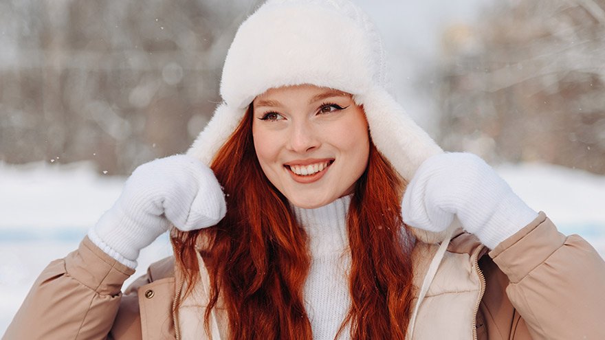 Young redhead woman in ice rink