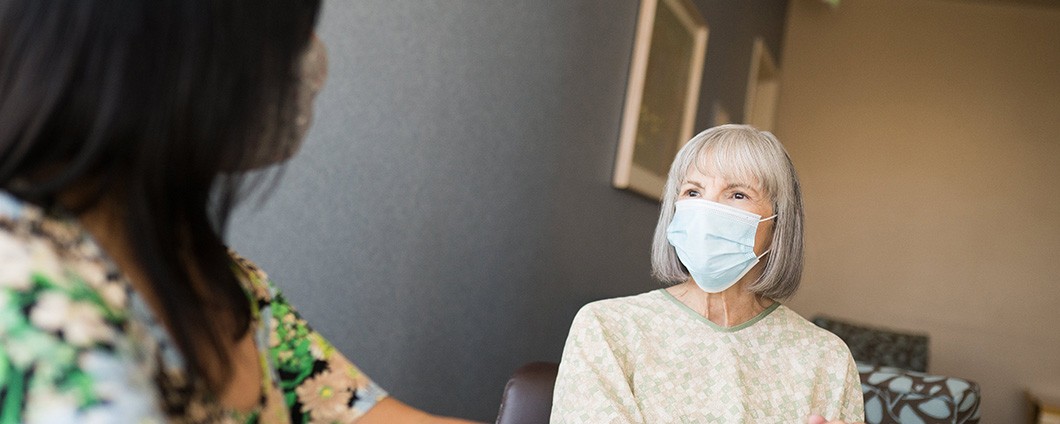 Two women visiting in a hospital room