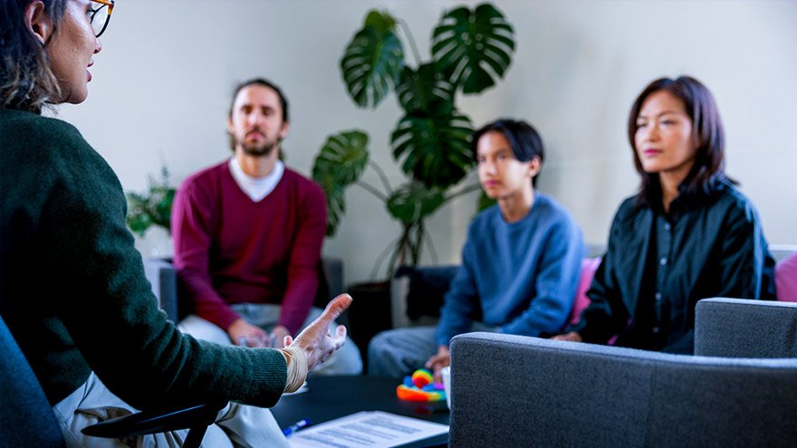 Parents and son talking to mental health professional