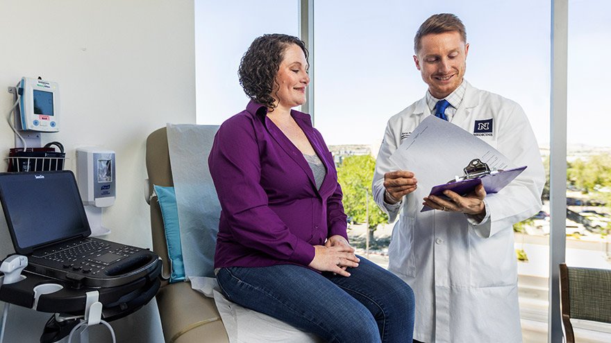 Dr. Falk consults with a female patient at Renown