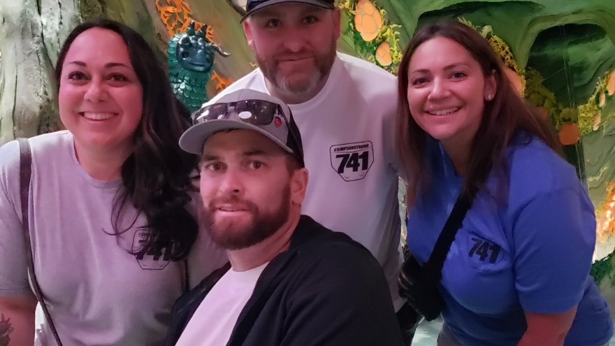 Jason Simpson poses with coworkers and family