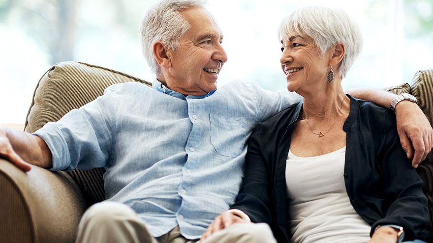 Older couple sitting together on sofa