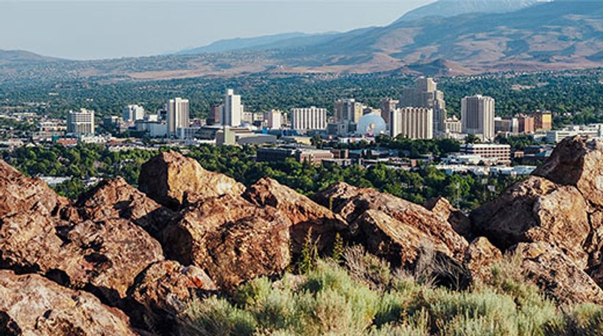 Landscape photo of downtown Reno with rocks in foreground 