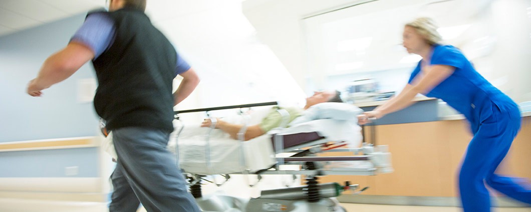 ER attendants rushing a patient into emergency room