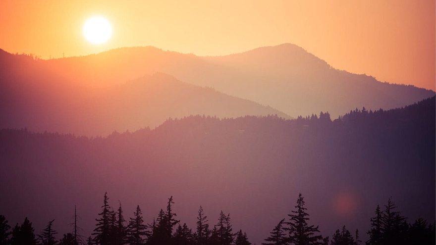 Sun shining above hills