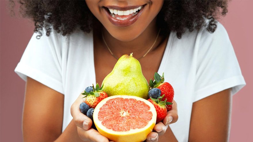 A lady holding fruits